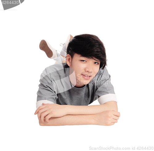 Image of Young Asian man lying on floor.