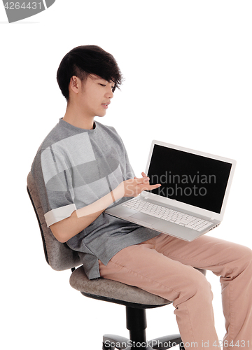 Image of Asian teenager pointing at his laptop.