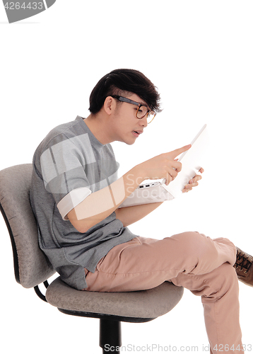 Image of Asian man working at his laptop.