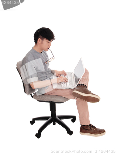 Image of Korean man typing at his laptop.