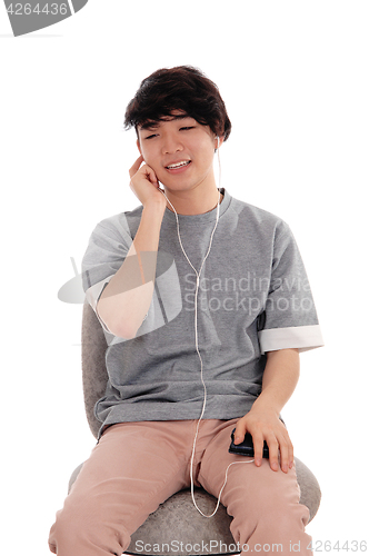 Image of Asian teenager listening to music.