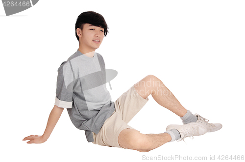Image of Asia teenager sitting on floor.