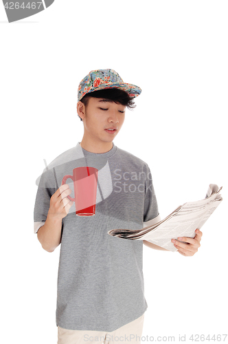 Image of Asian man with coffee and newspaper.