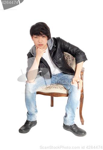 Image of Asian teenager sitting in chair.