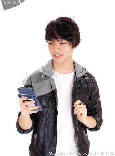 Image of Asian teenager looking at his cellphone.