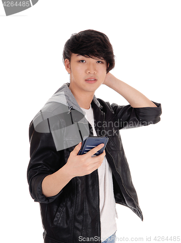 Image of Asian teenager looking at his cellphone.