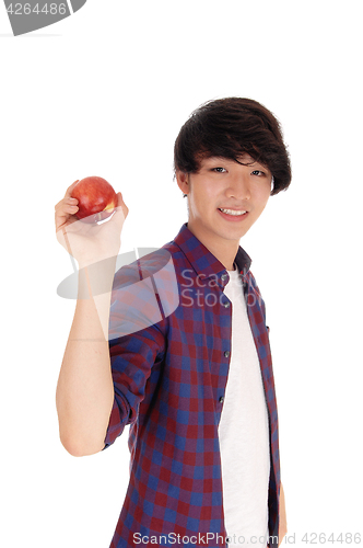 Image of Happy teenager holding red apple.