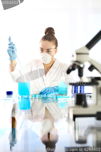 Image of The doctor examines the sample under a microscope.