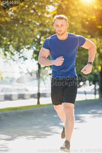 Image of Man running in park at morning. Healthy lifestyle concept