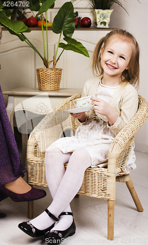 Image of little cute blonde european girl playing at home interior, lifes