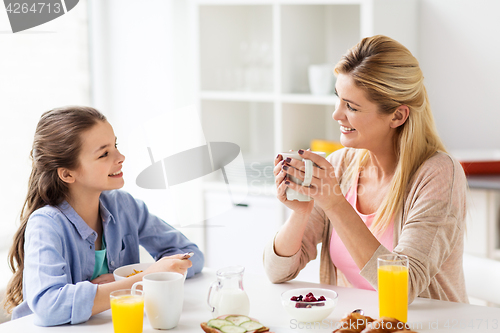 Image of happy family having breakfast at home kitchen