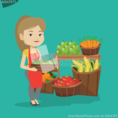 Image of Supermarket worker with box full of apples.