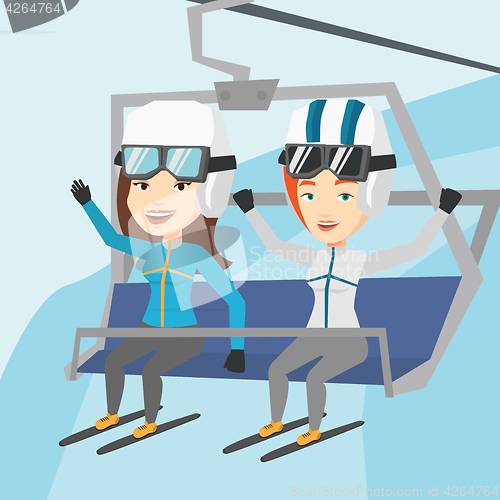 Image of Two happy skiers using cableway at ski resort.