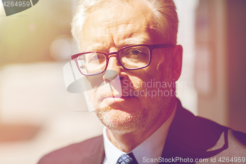 Image of close up of senior businessman in eyeglasses