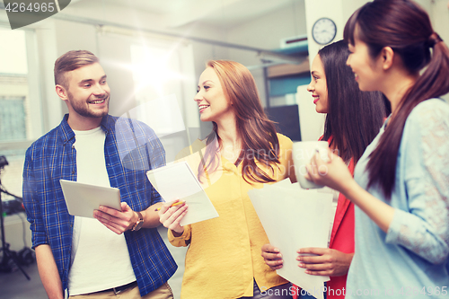 Image of creative team on coffee break talking at office