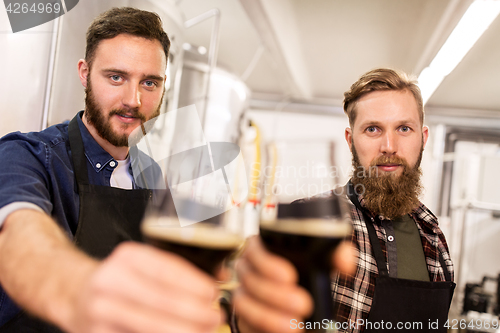 Image of men drinking and testing craft beer at brewery