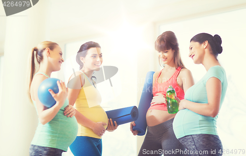 Image of group of happy pregnant women talking in gym