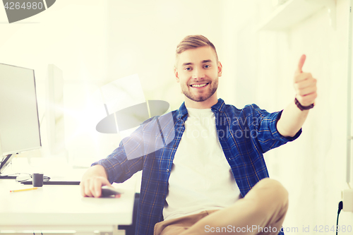 Image of happy creative man with computer at office