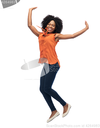 Image of happy african american woman jumping over white