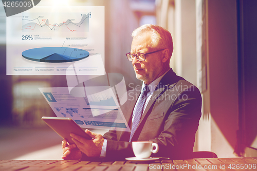 Image of senior businessman with tablet pc drinking coffee