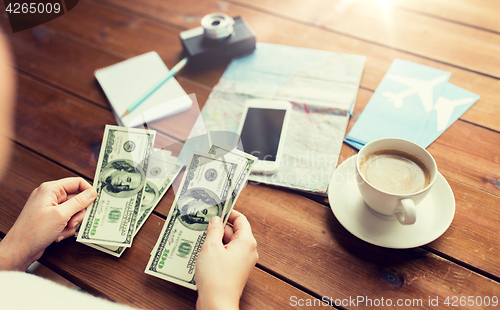 Image of close up of traveler hands counting dollar money