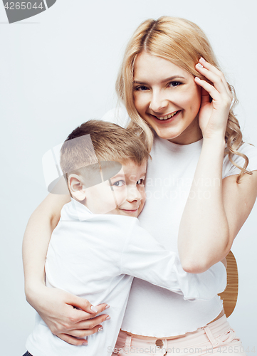 Image of young modern blond curly mother with cute son together happy smiling family posing cheerful on white background, lifestyle people concept, sister and brother friends 