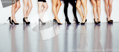 Image of diverse type pair of woman legs in hight heels black shoes isolated on white background and floor, diversity people lifestyle concept