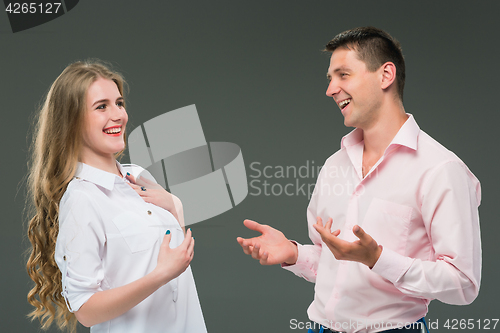 Image of Portrait of a young couple standing against gray background