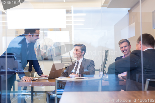 Image of Business people sitting and brainstorming at corporate meeting.