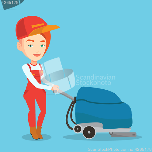 Image of Female worker cleaning store floor with machine.
