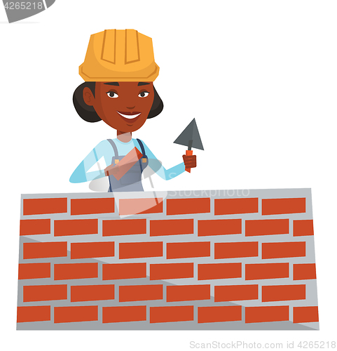 Image of Bricklayer working with spatula and brick.