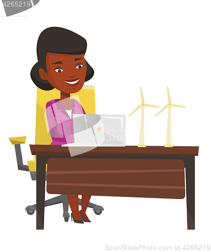 Image of Woman working with model wind turbines.