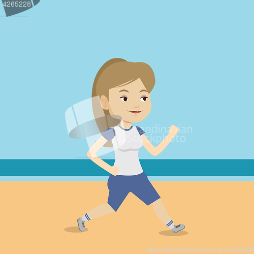Image of Young sporty woman jogging on the beach.