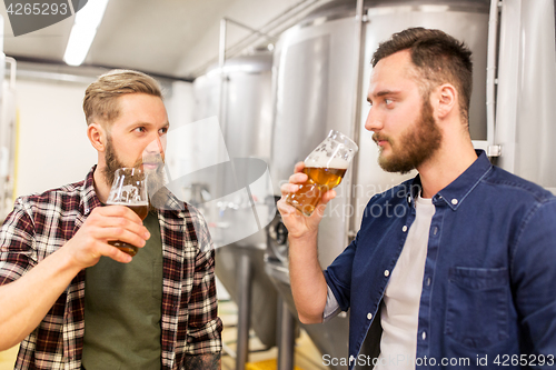 Image of men drinking and testing craft beer at brewery