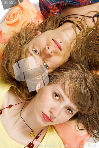 Image of Portrait of the young beautiful couple laying on a pillow