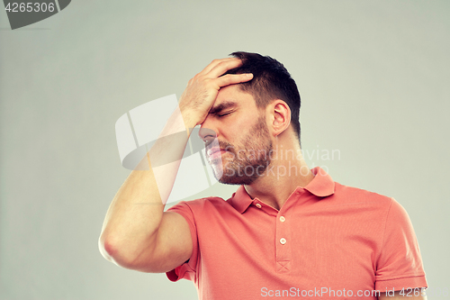 Image of unhappy man suffering from head ache