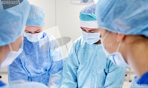 Image of group of surgeons in operating room at hospital