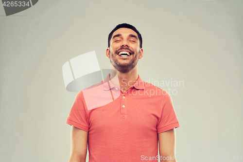 Image of laughing man over gray background