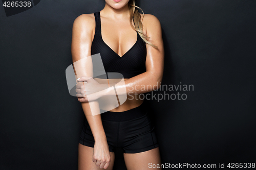 Image of close up of woman in black sportswear posing