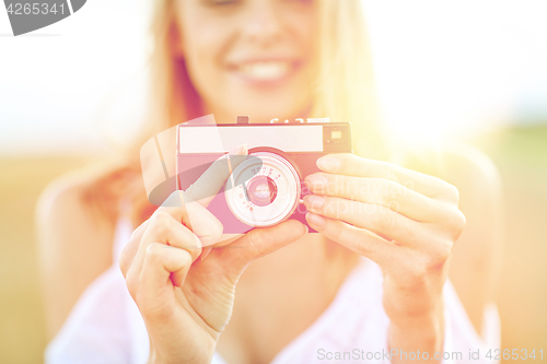 Image of close up of woman photographing with film camera