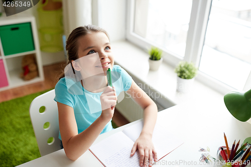 Image of happy girl with notebook dreaming at home