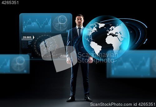 Image of businessman with earth globe hologram over black