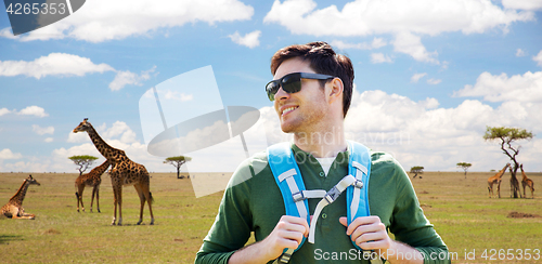 Image of happy young man with backpack traveling in africa