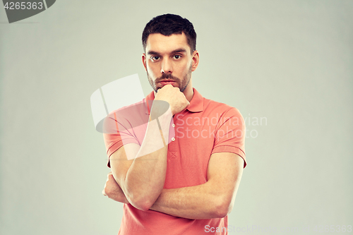 Image of man thinking over gray background