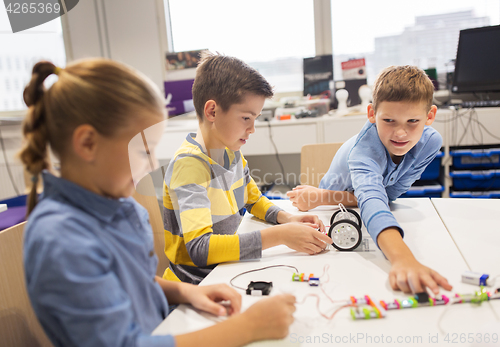 Image of happy children building robots at robotics school