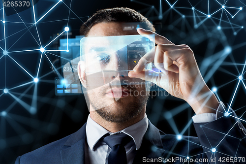 Image of businessman with transparent smartphone