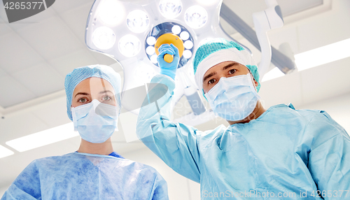 Image of group of surgeons in operating room at hospital