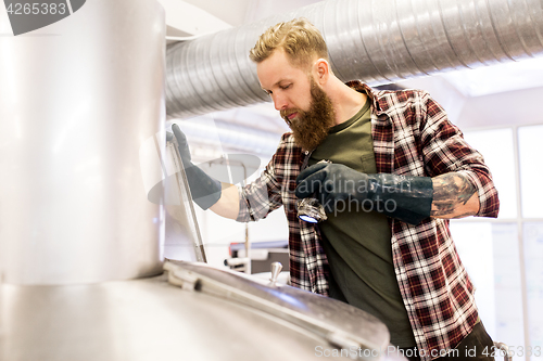 Image of man working at craft brewery or beer plant