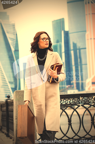 Image of Beautiful brunette in a light coat