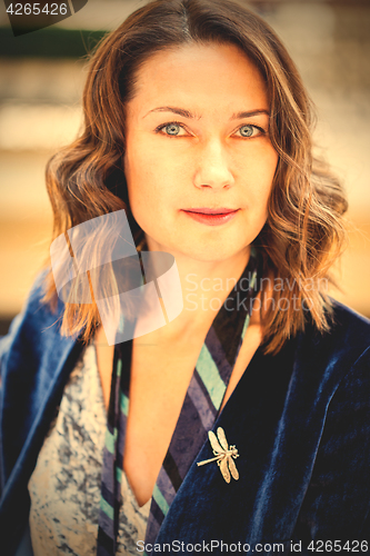 Image of beautiful woman with a dragonfly brooch